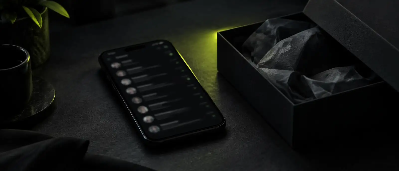A phone with a chat list beside an open gift box